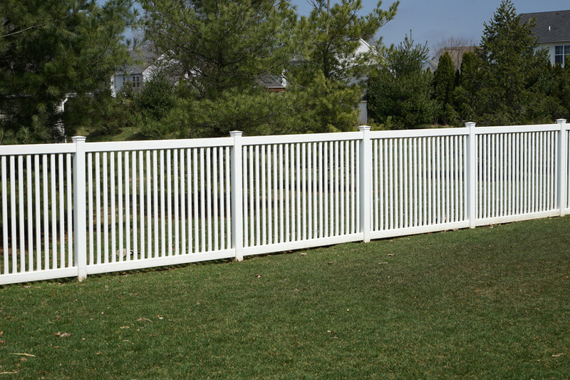 Newly installed vinyl fence. It is white, and there are pieces every 3 inches so there is a gap in between posts. The fence is about 3 feet tall. Installed in Kenosha.